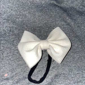 White bow on small black elastic